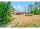 Rear view of a home with a large yard, showcasing its outdoor space and potential at 7340 West Dr, Wesley Chapel, FL 33544