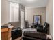 Finished basement space with cozy seating, wood-look flooring, and ample storage at 7340 West Dr, Wesley Chapel, FL 33544