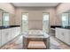 Luxurious main bathroom with a large soaking tub, double vanities, and and walk-in showers at 7340 West Dr, Wesley Chapel, FL 33544