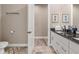 Well-lit bathroom featuring double sinks, granite countertops, and modern white cabinetry at 7340 West Dr, Wesley Chapel, FL 33544