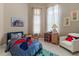 Cozy bedroom with bright natural light, themed decor, and comfortable furnishings at 7340 West Dr, Wesley Chapel, FL 33544