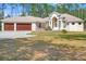 One story home with an arched entryway and a two car garage, plus lots of trees at 7340 West Dr, Wesley Chapel, FL 33544