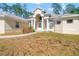 Pretty one story home with an arched entryway plus white pillars, and lots of trees at 7340 West Dr, Wesley Chapel, FL 33544