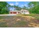 One story home with an arched entryway, two-car garage, and verdant lawn at 7340 West Dr, Wesley Chapel, FL 33544