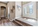 Bright foyer featuring decorative glass double doors and wood-look flooring at 7340 West Dr, Wesley Chapel, FL 33544