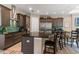 Gourmet kitchen featuring dark wood cabinetry, stainless steel appliances, and a large island with seating at 7340 West Dr, Wesley Chapel, FL 33544