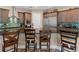 Open kitchen features dark wood cabinetry, a large island with bar seating, and modern stainless steel appliances at 7340 West Dr, Wesley Chapel, FL 33544