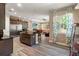 Open-concept kitchen with granite island, stainless appliances, and adjacent living area at 7340 West Dr, Wesley Chapel, FL 33544