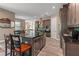 Spacious kitchen with an island, stainless steel appliances, dark cabinetry, and access to an open living area at 7340 West Dr, Wesley Chapel, FL 33544