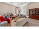 Bright living room showcasing hardwood floors, an elegant front door, and abundant natural light at 7340 West Dr, Wesley Chapel, FL 33544