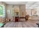 Open living room with light-toned wood flooring, tray ceiling, neutral color palette, and elegant furnishings at 7340 West Dr, Wesley Chapel, FL 33544