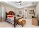 Spacious main bedroom featuring a tray ceiling, ceiling fan, and stylish decor at 7340 West Dr, Wesley Chapel, FL 33544
