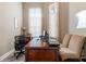 Functional home office with a spacious desk and natural light from two windows at 7340 West Dr, Wesley Chapel, FL 33544