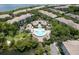 Aerial view of community pool, clubhouse, and surrounding lush landscaping at 736 Coral Reef Dr, Tampa, FL 33602