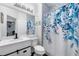 Stylish bathroom with modern fixtures, a decorative shower curtain, and ample lighting at 736 Coral Reef Dr, Tampa, FL 33602