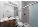 Modern bathroom with decorative tiles, a glass shower door, and a dark wood vanity at 736 Coral Reef Dr, Tampa, FL 33602