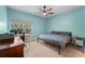 This is a nice bedroom with sleek wood floors, a comfortable bed, and lots of natural light from a large window at 736 Coral Reef Dr, Tampa, FL 33602