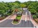 Aerial view of a gated entrance with lush landscaping and mature trees at 736 Coral Reef Dr, Tampa, FL 33602