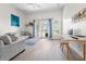 Cozy living room with neutral tones, a balcony with natural light, and minimalist décor at 736 Coral Reef Dr, Tampa, FL 33602