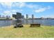 Scenic waterfront view featuring a picnic table and bench, with downtown buildings and boats creating a peaceful ambiance at 736 Coral Reef Dr, Tampa, FL 33602