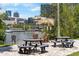 Stunning waterfront view with picnic tables, wooden chairs, and lush greenery against the backdrop of downtown buildings at 736 Coral Reef Dr, Tampa, FL 33602