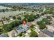 Aerial view of a lovely home with screened-in pool in a serene neighborhood near a lake, marked with a pin for easy location at 7657 Nottinghill Sky Dr, Apollo Beach, FL 33572