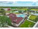Stunning aerial view of community featuring pool, tennis courts, playground, and lush green spaces for recreation and enjoyment at 7657 Nottinghill Sky Dr, Apollo Beach, FL 33572