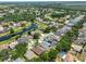 An overhead view of a suburban neighborhood featuring a winding waterway, displaying many lovely properties and green spaces at 7657 Nottinghill Sky Dr, Apollo Beach, FL 33572