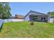 Expansive backyard with lush green grass, white fence, and exterior view of the home at 7657 Nottinghill Sky Dr, Apollo Beach, FL 33572