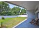 Large backyard with a covered patio area and white vinyl fencing, perfect for outdoor entertaining at 7657 Nottinghill Sky Dr, Apollo Beach, FL 33572