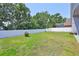 Spacious backyard with manicured lawn and privacy fence, ideal for outdoor activities at 7657 Nottinghill Sky Dr, Apollo Beach, FL 33572