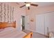 Comfortable bedroom with carpeted floors, closet, ceiling fan, and decor at 7657 Nottinghill Sky Dr, Apollo Beach, FL 33572