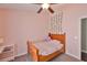 Comfortable bedroom with carpeted floors, ceiling fan, and decor at 7657 Nottinghill Sky Dr, Apollo Beach, FL 33572