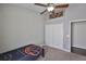 Neutral bedroom featuring carpeted floors, a ceiling fan, and a window with natural light at 7657 Nottinghill Sky Dr, Apollo Beach, FL 33572