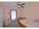 Cozy bedroom featuring carpeted floors, a ceiling fan, and a window with natural light at 7657 Nottinghill Sky Dr, Apollo Beach, FL 33572