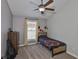 Comfortable bedroom with carpeted floors, a ceiling fan, and a window at 7657 Nottinghill Sky Dr, Apollo Beach, FL 33572