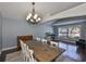 Dining room featuring hardwood floors, modern chandelier and a vaulted ceiling at 7657 Nottinghill Sky Dr, Apollo Beach, FL 33572