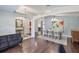 Spacious dining room featuring a large picture, hardwood floors and an open floor plan at 7657 Nottinghill Sky Dr, Apollo Beach, FL 33572