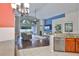 Bright living room featuring hardwood floors, high ceilings, and sliding glass doors to the backyard at 7657 Nottinghill Sky Dr, Apollo Beach, FL 33572