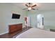 Relaxing main bedroom features an ensuite bathroom, stylish ceiling fan, and lots of natural light at 7657 Nottinghill Sky Dr, Apollo Beach, FL 33572