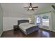 Comfortable main bedroom featuring a luxurious upholstered bed, ceiling fan, and lots of natural light at 7657 Nottinghill Sky Dr, Apollo Beach, FL 33572