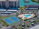 Community view with tennis courts, swimming pool, and boat dock, offering many recreational amenities at 7665 Sun Island S Dr # 307, South Pasadena, FL 33707