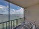 Balcony with waterfront view, seating and wind chimes at 7665 Sun Island S Dr # 307, South Pasadena, FL 33707
