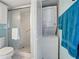 Bathroom featuring a shower, toilet, and stackable washer and dryer for added convenience at 7665 Sun Island S Dr # 307, South Pasadena, FL 33707