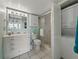 Bathroom with a vanity, sink, toilet, and walk-in shower at 7665 Sun Island S Dr # 307, South Pasadena, FL 33707