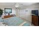 Bedroom featuring a ceiling fan, closet, dresser, and an ocean view window at 7665 Sun Island S Dr # 307, South Pasadena, FL 33707