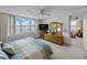 Bright bedroom with a waterfront view and furnishings at 7665 Sun Island S Dr # 307, South Pasadena, FL 33707