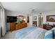 This bedroom features a large window, a dresser with a mirror, and a work desk in the corner at 7665 Sun Island S Dr # 307, South Pasadena, FL 33707