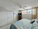 Relaxing bedroom with closet doors and a bed with a patterned blue quilt at 7665 Sun Island S Dr # 307, South Pasadena, FL 33707
