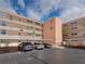 Exterior view of the building with covered parking, showcasing its architecture and landscaping at 7665 Sun Island S Dr # 307, South Pasadena, FL 33707
